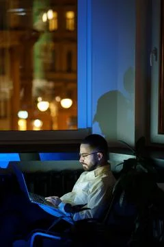 Journalist or pr manager work overtime. Male programmer focused on fixing bugs Stock Photos