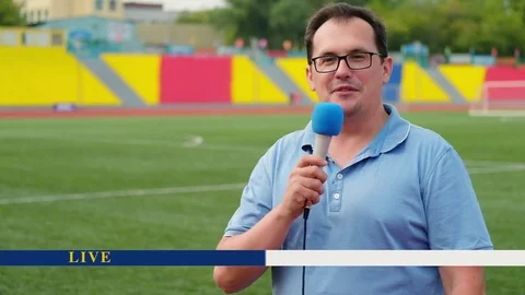 The journalist is reporting from the stadium for television with breaking news p Stock Footage