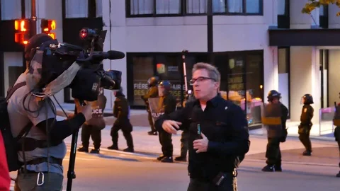 Journalist talking to the camera after a protest Stock Footage 92440857
