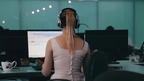 A journalist working on a computer in Newsroom Video stock 75950300