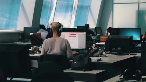A journalist working on a computer in Newsroom Video stock 75950307