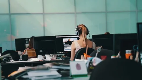 A journalist working on a computer in Newsroom Video stock 75950425