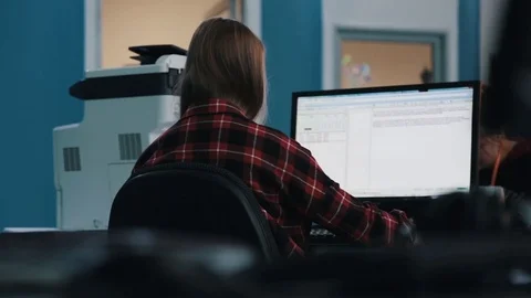 A journalist working on a computer in Newsroom Video stock 75950442