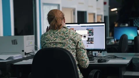 A journalist working on a computer in Newsroom Video stock 75950468