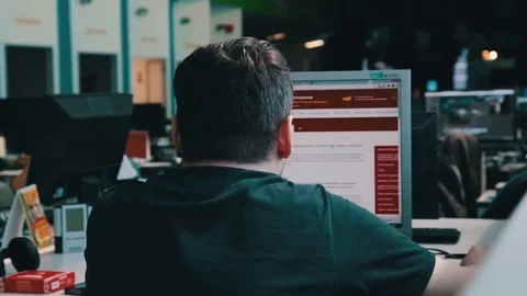 A journalist working on a computer in Newsroom Stock Footage 75950508