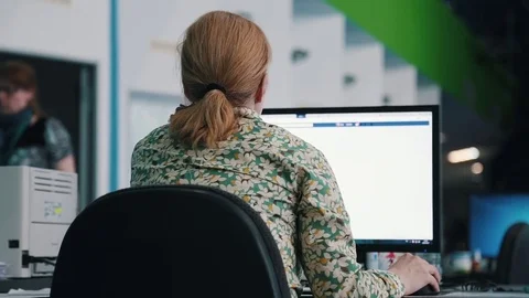 A journalist working on a computer in Newsroom Stock Footage 75950558
