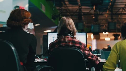 A journalist working on a computer in Newsroom Video stock 75950566