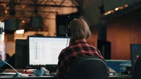 A journalist working on a computer in Newsroom Stock Footage 75950579