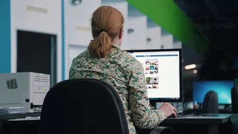 A journalist working on a computer in Newsroom Video stock 75950603