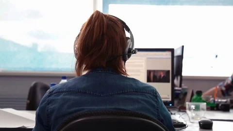 A journalist working on a computer in Newsroom Stock Footage 76000295
