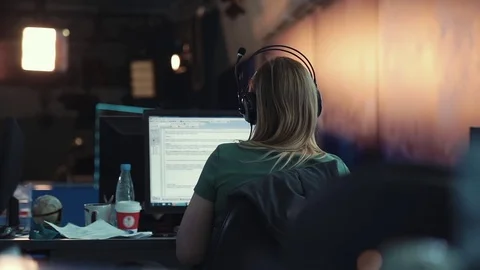 A journalist working on a computer in Newsroom Stock Footage 76000426