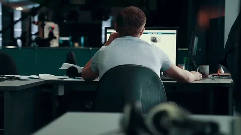 A journalist working on a computer in Newsroom Stock Footage 76130846