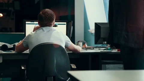 A journalist working on a computer in Newsroom Stock Footage 76130847