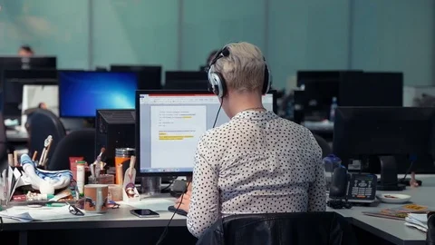 A journalist working on a computer in Newsroom Stock Footage 76400603