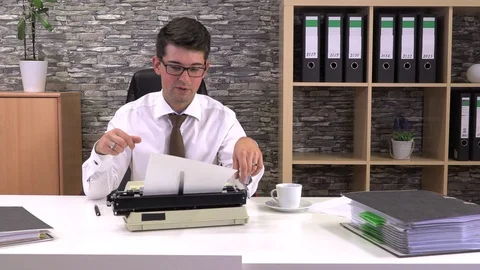 Journalist writes an article on a typewriter at a table in the workplace Stock Footage 115789300
