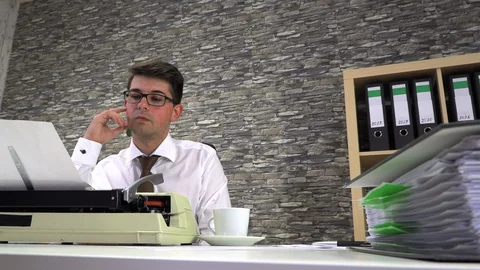 Journalist writes an article on a typewriter at a table in the workplace Stock Footage 115878950
