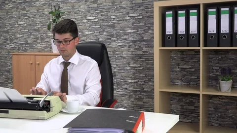 Journalist writes an article on a typewriter at a table in the workplace Stock Footage 115879141