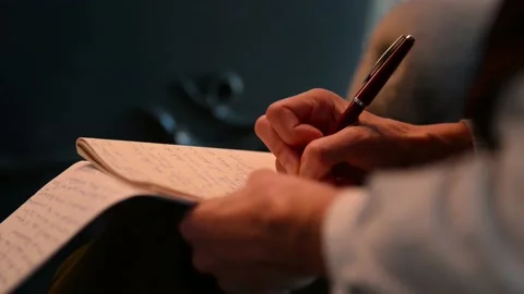 Journalist writing notes in notebook at desk Stock-Footage 132755229