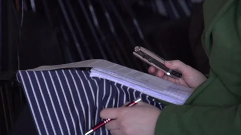 Journalist's hand with recorder, pen, program and notebook Stock Footage 240750179