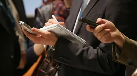 Journalists take audio interview at press conference Stock Footage 22358306