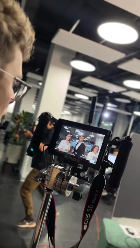 Journalists work in office as seen through digital camera display Stock Footage 303065277