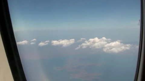 Journey above the Clouds from a Plane Window near Bali Stock Footage 312529484