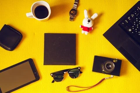 Journey. objects on a yellow background. coffee, technology, clock, toy, note Fotos Stock