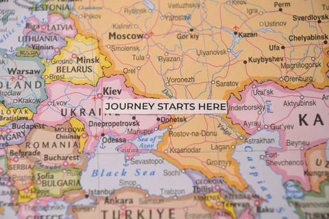 Journey starts here text label positioned on a geographical world map highl.. Stock Photos