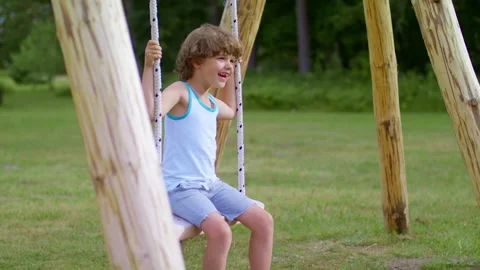 The joy of a child. The boy is swinging on a swing. Stock Footage 219316086