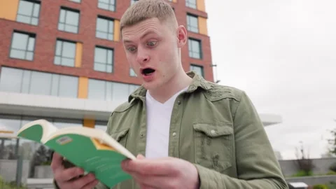 The Joy of Learning A Young Man Overwhelmed with Knowledge Outdoors Stock Footage 323925258