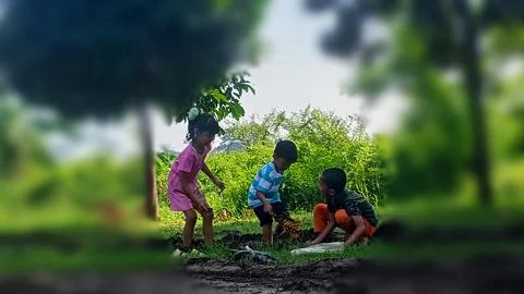 The joy of three small children playing with water and mud. Stock Photos