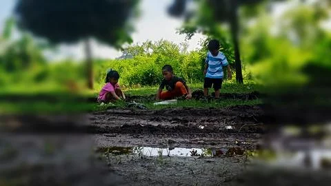 The joy of three small children playing with water and mud. Stock Photos