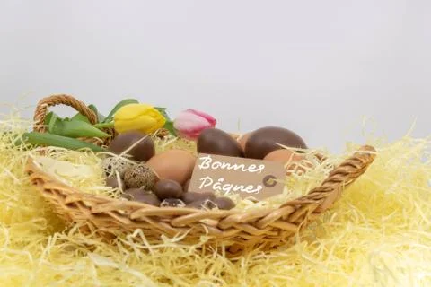Joyeuses Pâques is Happy Easter written in French with eggs and tulips Stock Photos