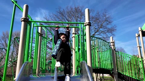 Joyful 4-Year-Old Child Playing On Green Playground Slide And Monkey Bars On Stock Footage 331601530