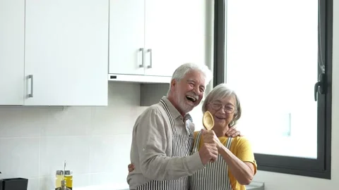 Joyful active old retired romantic couple dancing laughing in living room, happy Stock Footage 237939527
