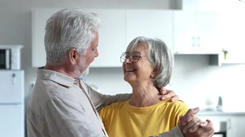 Joyful active old retired romantic couple dancing laughing in living room, happy Stock Footage 237941451