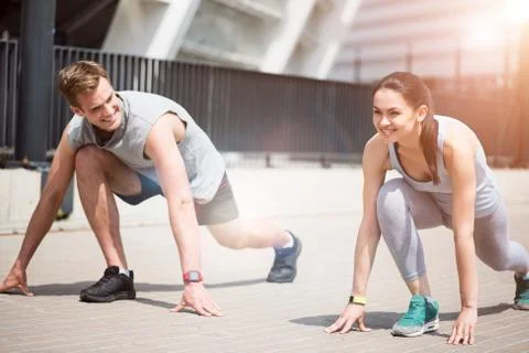 Joyful active people preparing for a run together Stock Photos