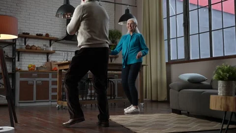 Joyful aged couple dancing during home leisure Stock Footage 150711886