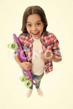 Joyful and happy. Kid girl casual style with penny board enjoy childhood. Girl Stock Photos