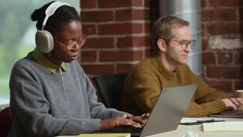 Joyful Black Female Programmer Enjoying Listening to Music at Workplace Video stock 320001622