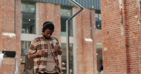 Joyful Black millennial guy dancing while listening to music in headphones. Stock-Footage 245153374