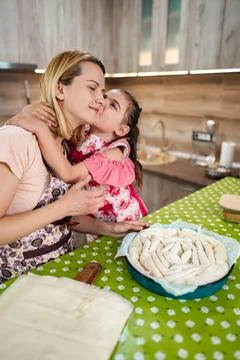 Joyful bonding while preparing traditional dumplings in a cozy kitchen Stock Photos