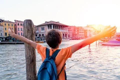Joyful Boy with Backpack Overlooking Venice Canal Stock Photos
