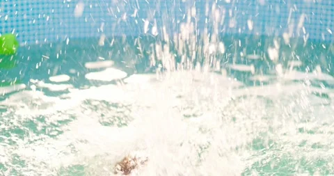 Joyful boy jumping into the pool in the backyard enjoying his summer vacation Stock Footage 254280314