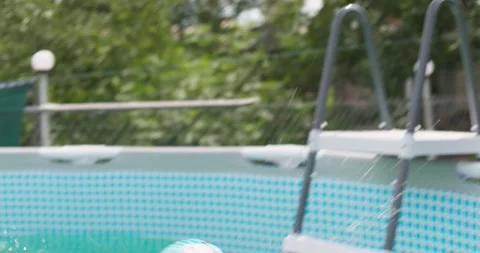 Joyful boy jumping into the pool in the backyard enjoying his summer vacation Stock Footage 255661820