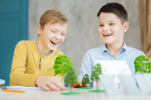 Joyful boys having fun while working on ecology project Stock-Fotos