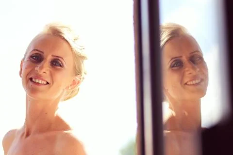 Joyful bride getting professional make up before wedding Stock Photos