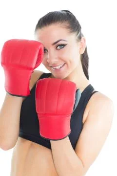 Joyful brunette woman wearing boxing gloves smiling at camera Stock Photos
