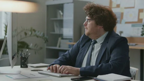 Joyful Businessman Using Computer and Celebrating Achievement in Office Stock Footage 331557250