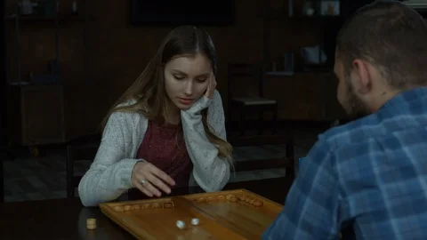 Joyful charming girl playing backgammon at home Stock Footage 87254758